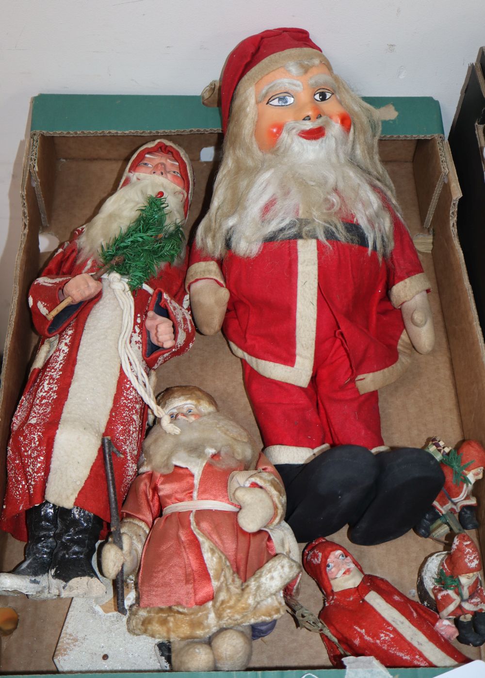 Six Father Christmas figures, 5 early ones holding feather trees and 2 detached from feet, feet present, large figure 17in.